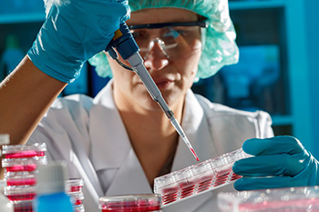 Lab researcher filling test tubes with blood