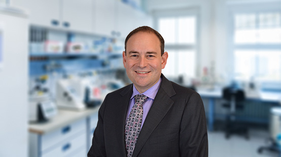 Dr. Bruce Sachais Exec VP/Chief Medical Officer at New York Blood Center Enterprises, smiling in laboratory