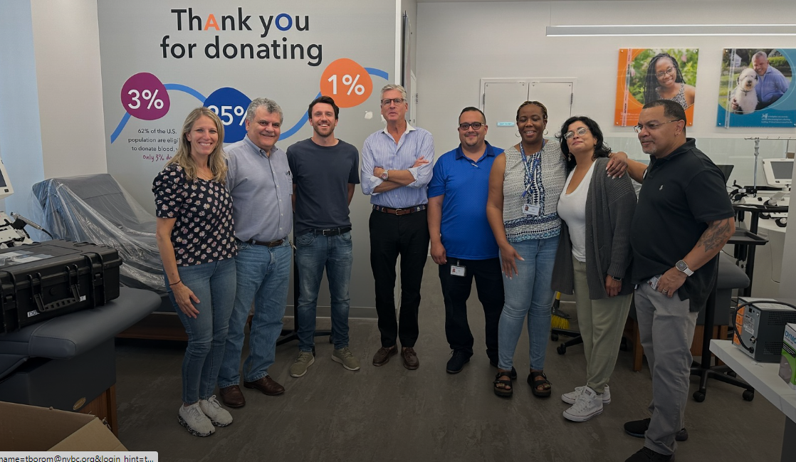 NYBCe President and CEO Christopher D. Hillyer, MD’, standing with seven Fishkill staff members at Fishkill Donor Center in Fishkill, New York